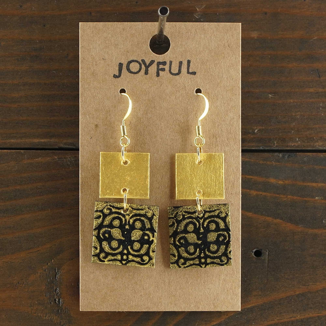 Large, lightweight, two-tiered, square statement earrings. Handmade and hand painted in black and gold. Made from recycled paper.