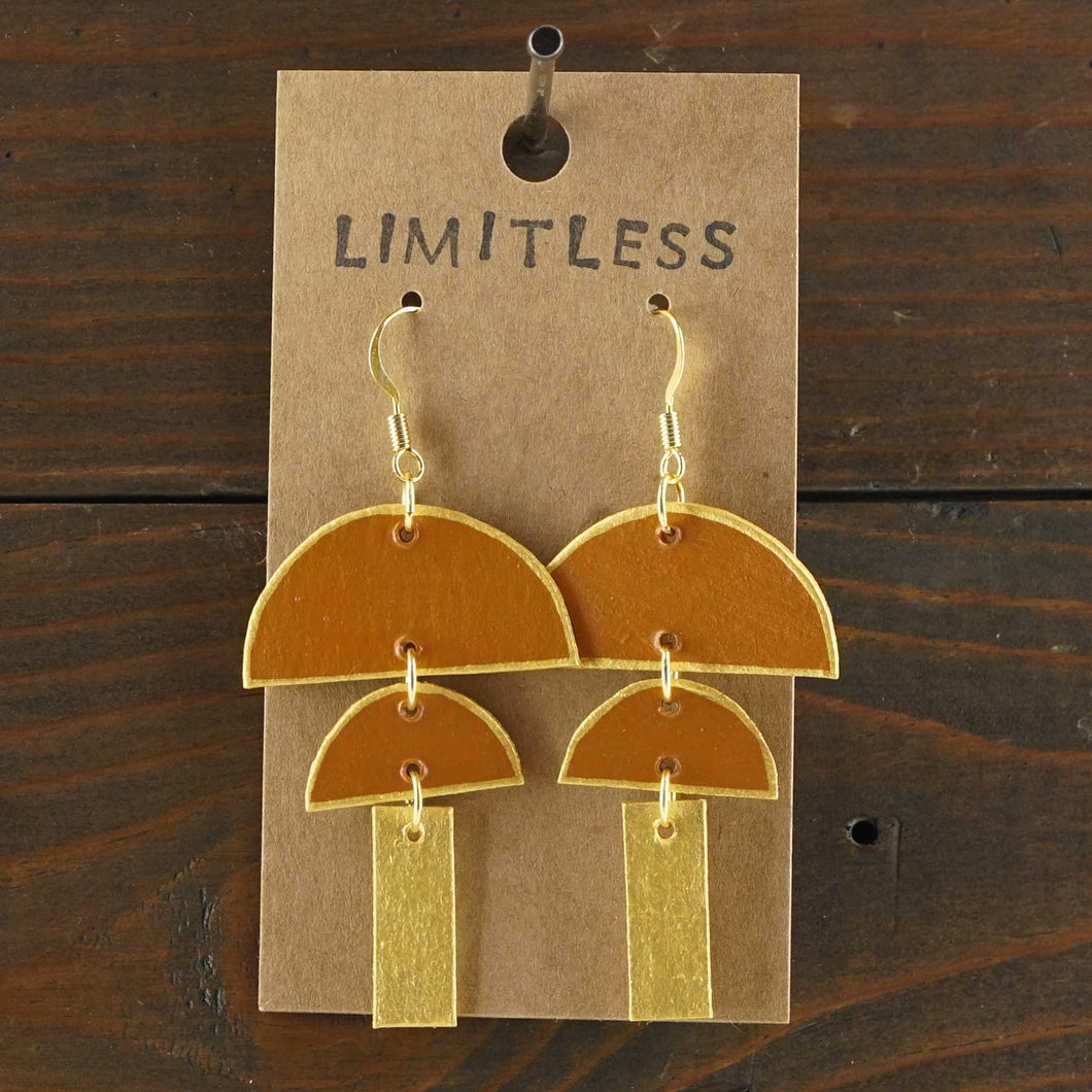 Large, lightweight, geometric statement earrings. Handmade and hand painted in terra cotta and gold. Made from recycled paper.